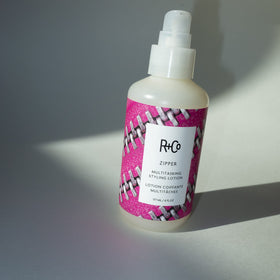 R+Co Zipper label detail emphasizing Dark Waves scent notes and premium benefit