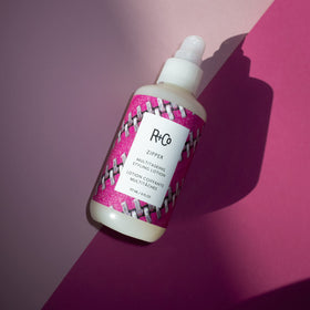 R+Co Zipper bottle beside common objects showing 6 oz size and travel-friendly benefit