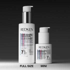 Redken bottle beside hand for scale and travel-friendly convenience