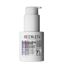 Redken bottle front packaging showing brand and repair benefits