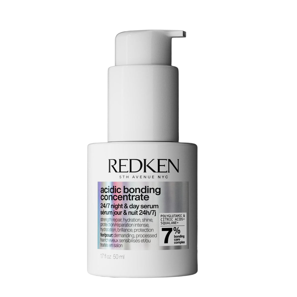 Redken bottle front packaging showing brand and repair benefits