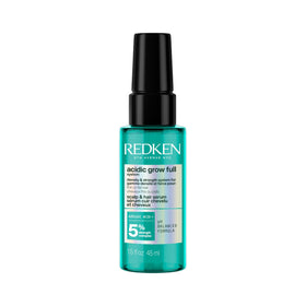 Redken bottle front packaging showing treatment benefits and branding
