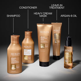 Redken All Soft on bathroom shelf with towel, evoking professional everyday hair care