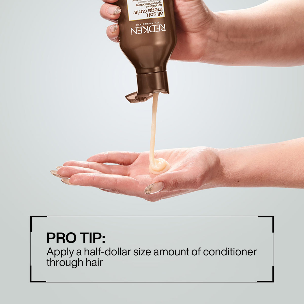 Redken conditioner in hands illustrating generous slip for detangling