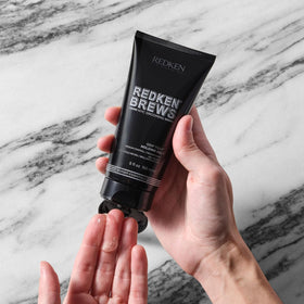 Redken Brews applied to curly hair demonstrating definition and movement