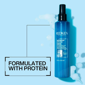 Redken Extreme Anti-Snap size comparison next to hand to show convenient leave-in bottle
