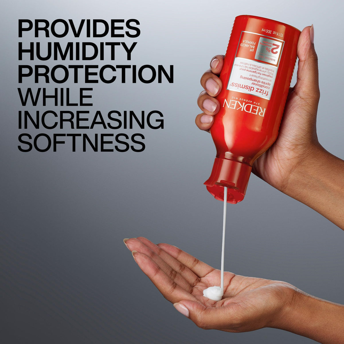 Redken conditioner applied in hand showing detangling and hydration