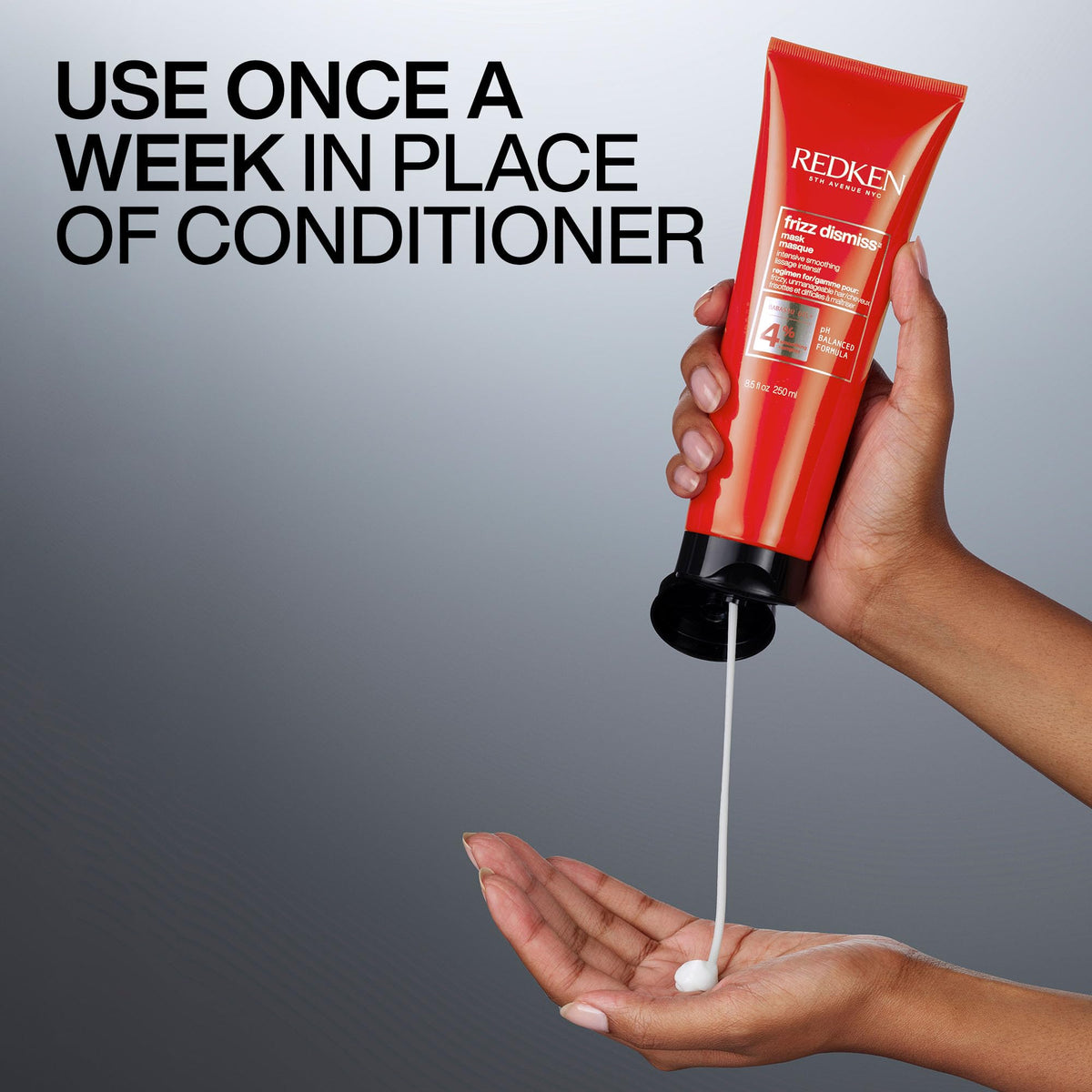 Applying Redken Frizz Dismiss mask to midlengths for smoother styling benefit