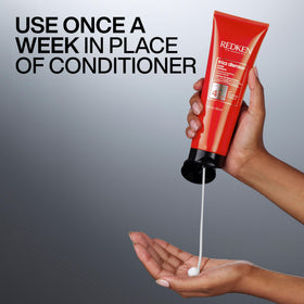 Applying Redken Frizz Dismiss mask to midlengths for smoother styling benefit
