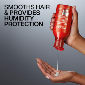 Redken bottle staged in bathroom for easy daily frizz care