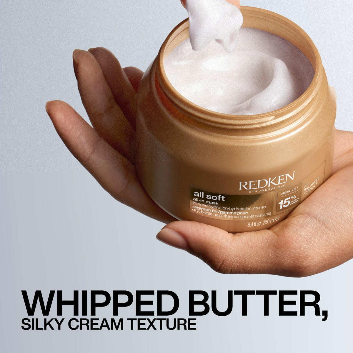 Redken jar held in hand to show actual size and travel-friendly scale