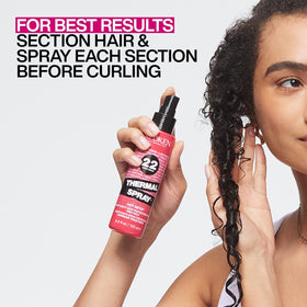 Redken in use while styling with a flat iron for heat defense
