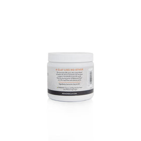 Person applying Redmond clay mask to cheek, brand visible, promotes clearer-looking skin