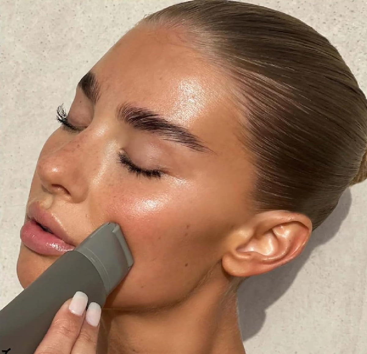 R.E.F.Y serum applied with roller on cheek for instant hydration and smooth base
