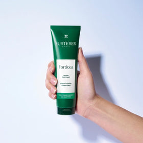René Furterer conditioner bottle next to Forticea shampoo for routine