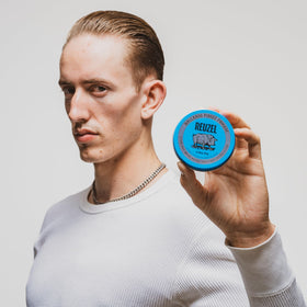 REUZEL on a barber station displaying professional use and reliable styling results