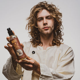 REUZEL Surf Tonic styled model with beachy waves showcasing natural matte finish