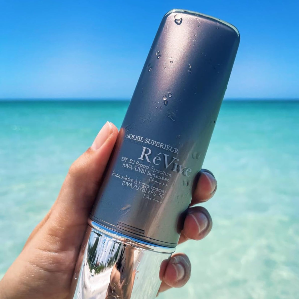 RéVive Soleil Superiéur 1.7 oz size next to coin for scale and travel-friendly benefit