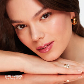 REVLON balm held in hand to show compact size and travel convenience