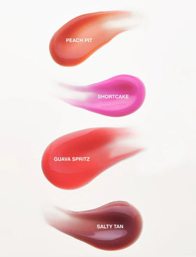 Rhode gloss lip tint on model lips offering natural warm shine and dimension
