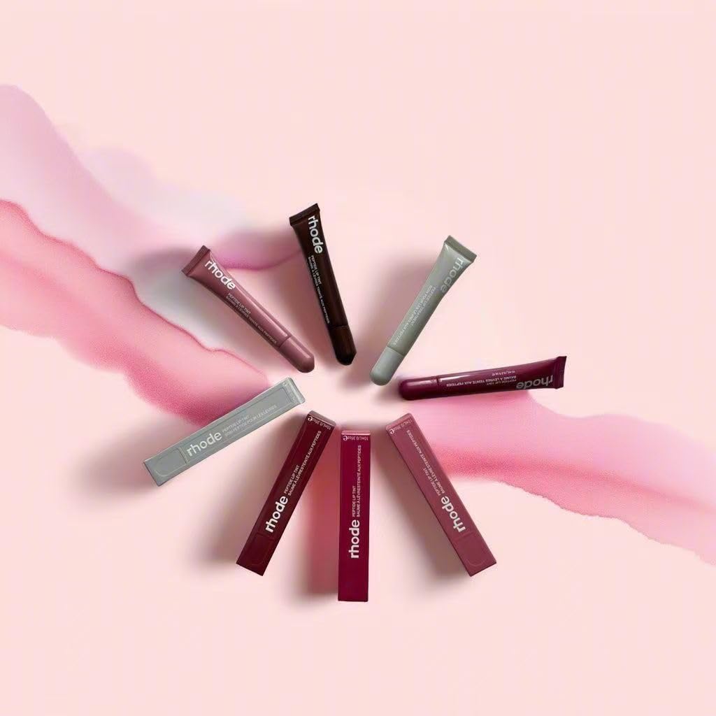 Rhode gloss lip tint swatch on arm demonstrating buildable toast color