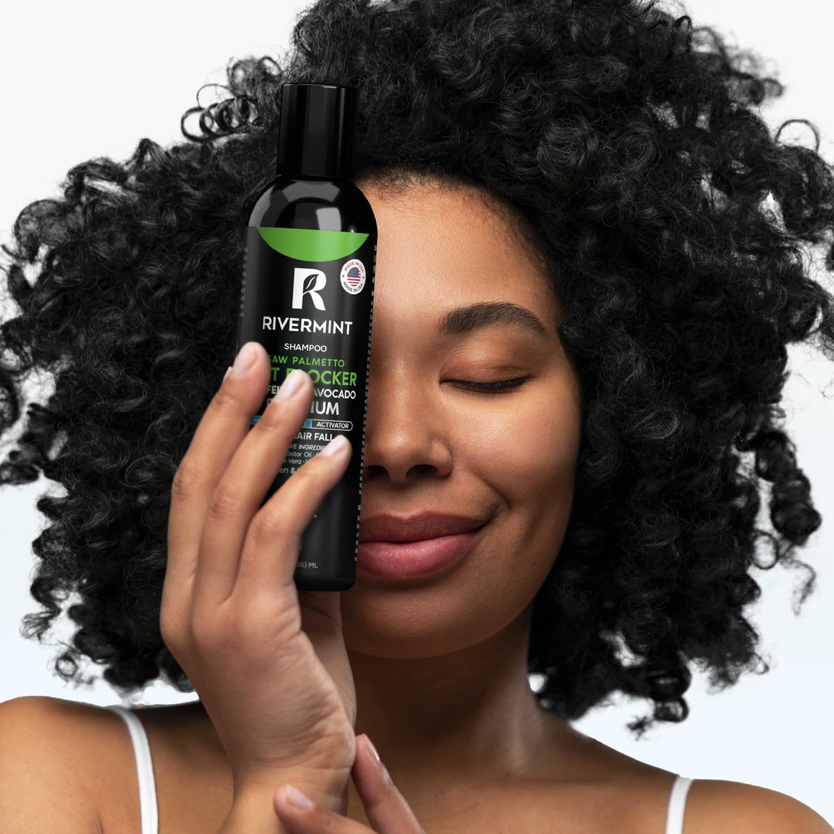 Rivermint bottle in a hand for scale, communicates travel-friendly size and convenience