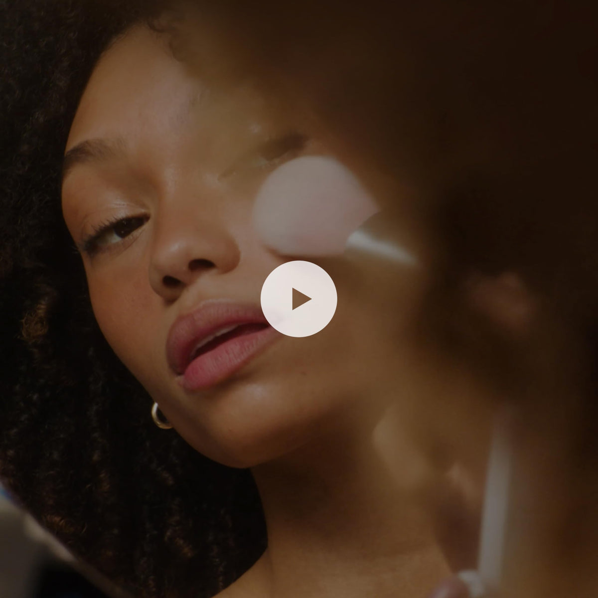 RMS Beauty hydra-bronzer applied to cheek in lifestyle shot for subtle contour and glow