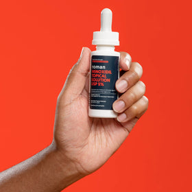 Ro 5% minoxidil bottle on bathroom shelf showing daily grooming fit