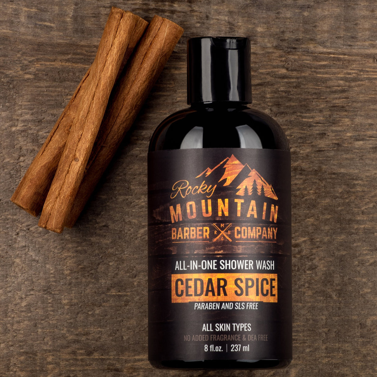 Rocky Mountain Barber Company bottle next to a phone for size scale and convenience