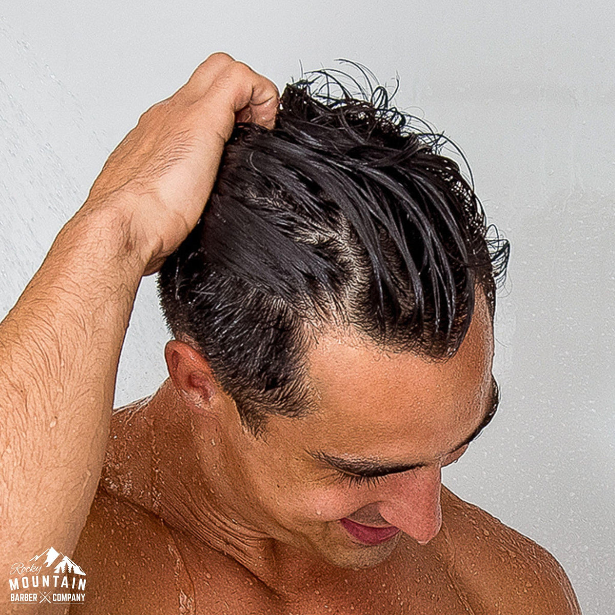Rocky Mountain Barber Company man using conditioner conveying effortless grooming
