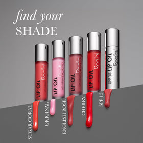 Rodial lip oil next to lipstick combo illustrating layering for shine and moisture
