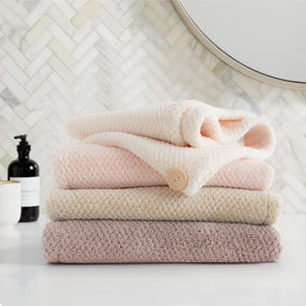 ROLSHOL woman relaxed post-shower wearing turban showing reduced frizz and gentle care