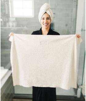 ROLSHOL towel shown on model for size comparison, helps visualize coverage