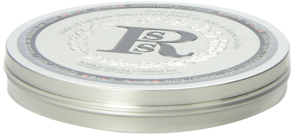 Rosebud Perfume tube on a desk next to a mug illustrating everyday use and quick touch-up convenience