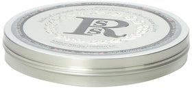 Rosebud Perfume tube on a desk next to a mug illustrating everyday use and quick touch-up convenience