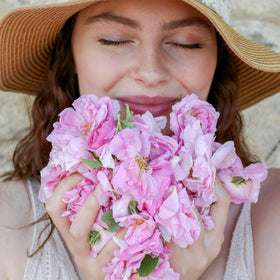 Rosense mist spraying on face demonstrating gentle hydration and midday refresh