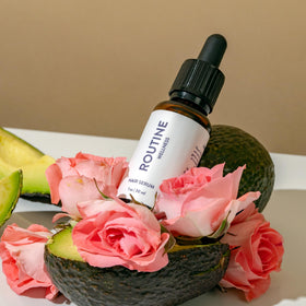 Routine Wellness bottle on bathroom shelf in daily grooming setting