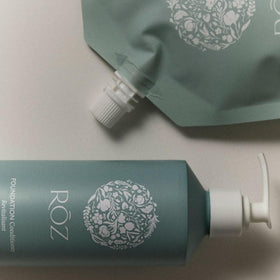 RŌZ aluminum bottle being refilled from pouch illustrating plastic reduction