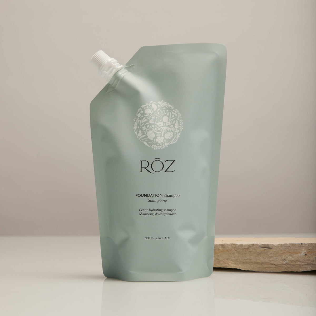 RŌZ refill pouch being poured into bottle illustrating easy refill benefit