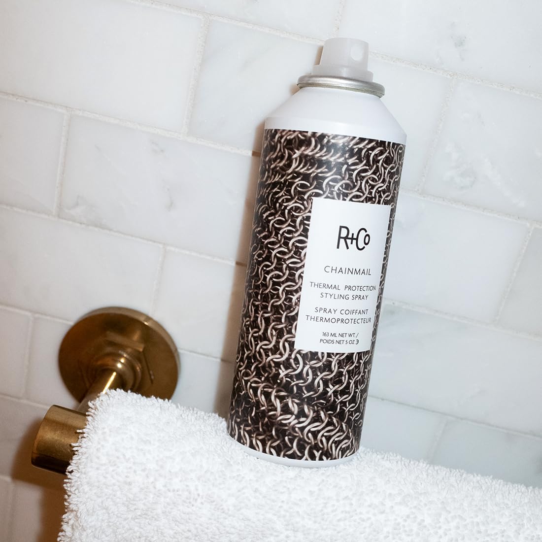 R+Co Chainmail bottle in hand to show true 5 oz size and portability