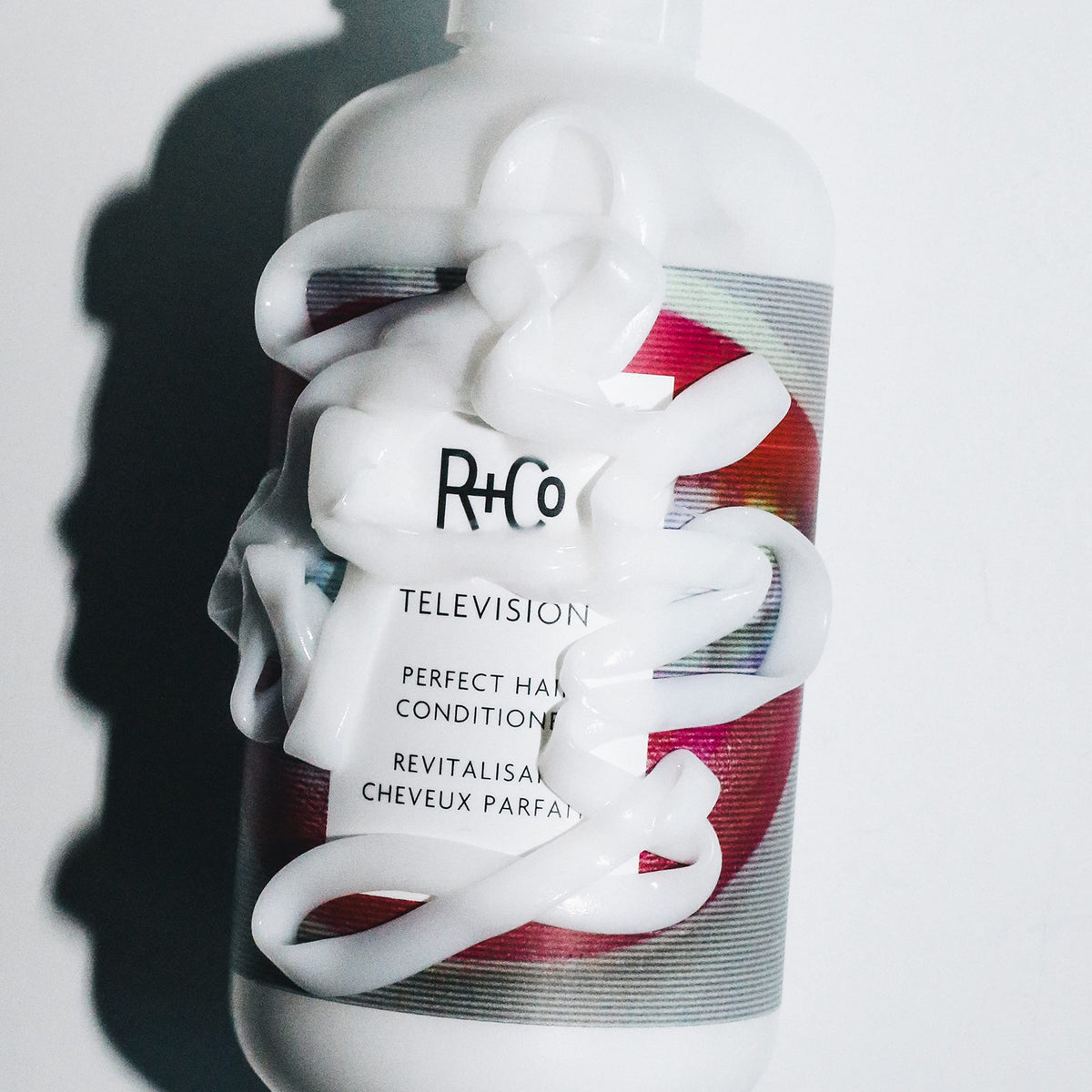 R+Co Television conditioner in salon setting on shelf showing professional-grade supply advantage