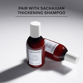 SACHAJUAN bottle in hand to show 8.4 fl oz size and travel-friendly benefit
