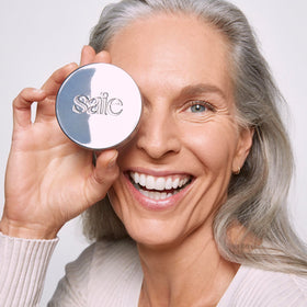 Saie Airset beside a lipstick showing compact 0.14 oz travel-friendly size