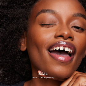 Saie Dew Bronze applying to cheek showing targeted sculpting for natural definition