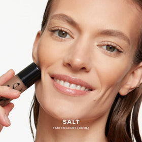 Saie product in use on cheek delivering targeted sun-kissed warmth