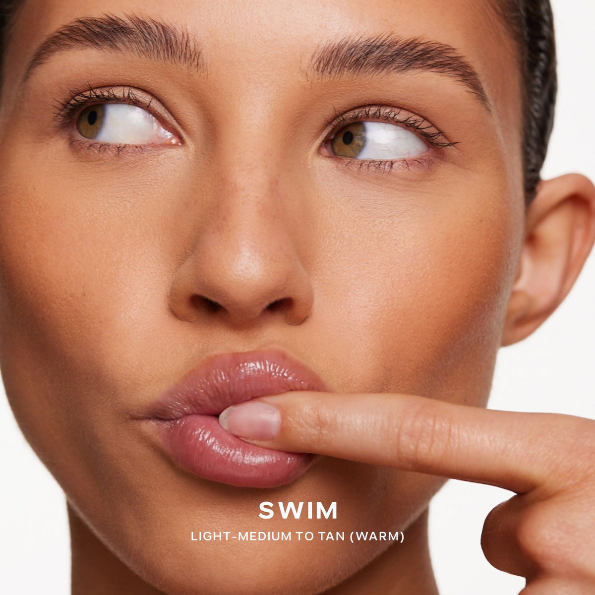 Saie bronzer placed under cheek to sculpt jawline for soft natural definition