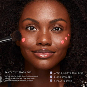 Saie applying blush to cheek with finger for natural, dewy color