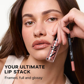 Saie gloss in hand next to coin showing .17 oz travel-size convenience