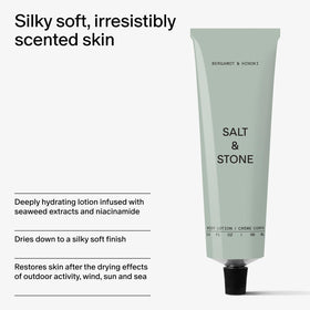Salt & Stone bottle next to smartphone to show travel-friendly size