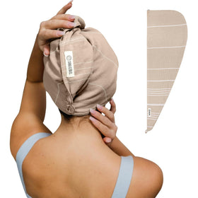 Sand Cloud folded hair towel showing compact sand color and soft feel for quick drying